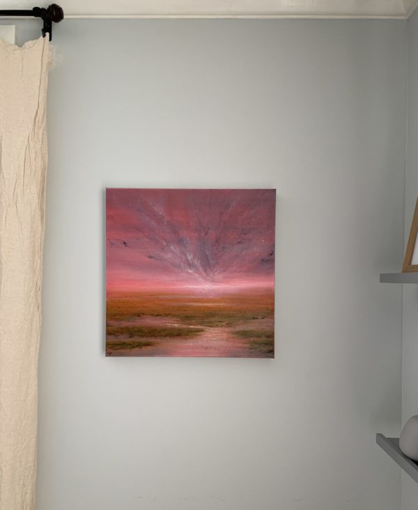 Original marsh landscape oil painting by Tisha Mark. "Possibilities" 16"x16" oil on canvas (2023). Painting of a coastal marsh underneath a brilliant pink sunrise or sunset sky. Shown here in situ.